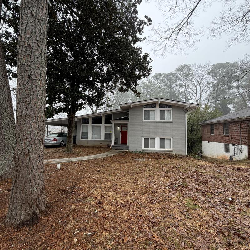Rolled roofing with tarp on two-story house