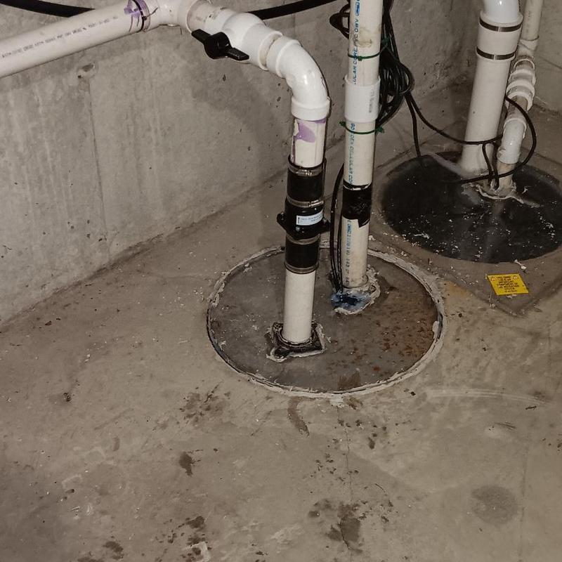 Grinder pump and PVC piping in basement sump pit