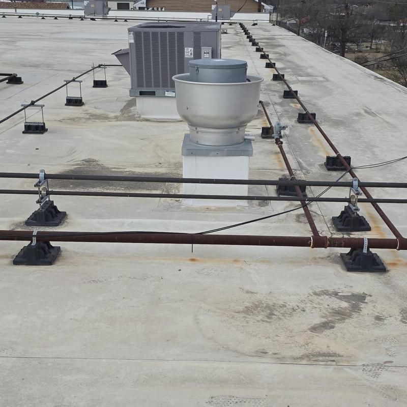 Roof ventilation fan and HVAC units on flat roof