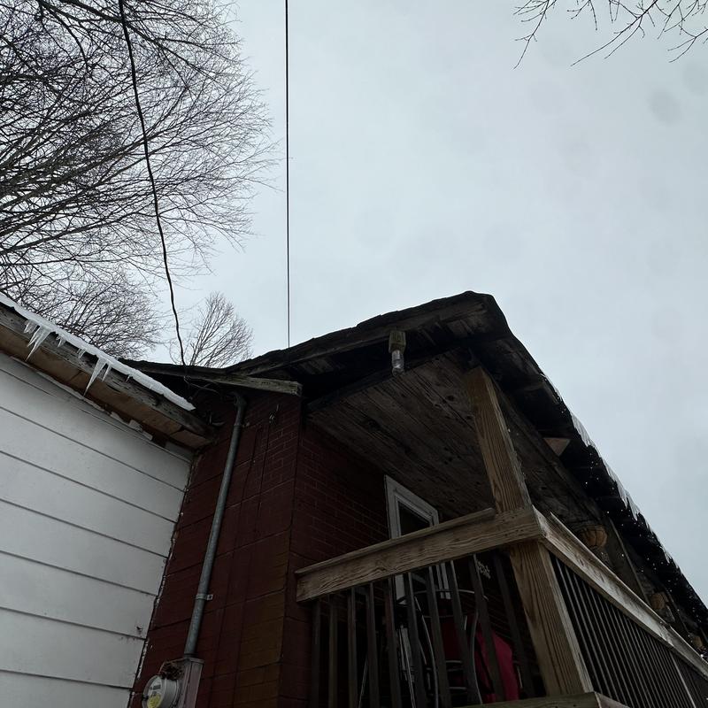50-year shingle roof with icicles and porch railing