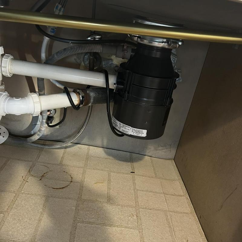 Garbage disposal unit under kitchen sink installation