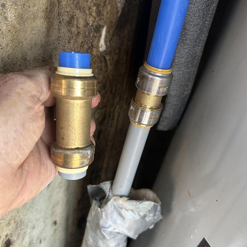 Hot water pipe fitting near water heater leak
