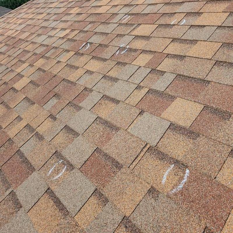 Asphalt shingle roof with hail damage markings