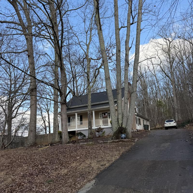 Roof dipping and siding damage on two-story house
