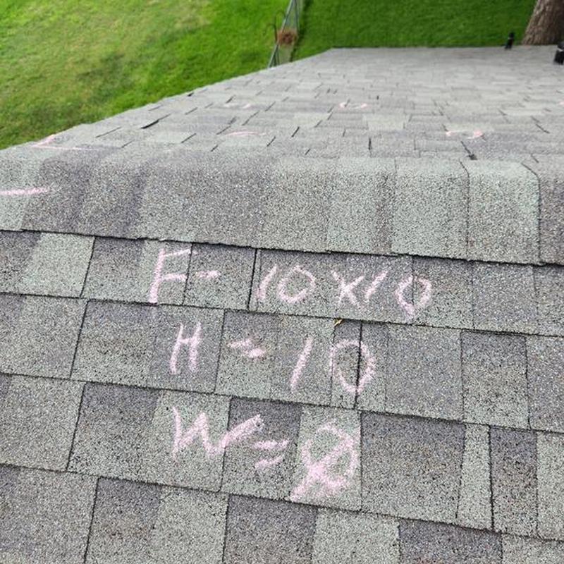 Asphalt shingle roof with inspection markings