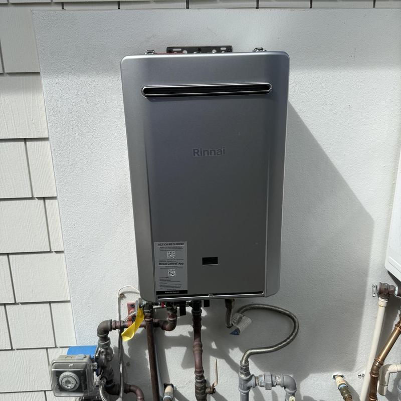 Tankless water heater installation on exterior wall