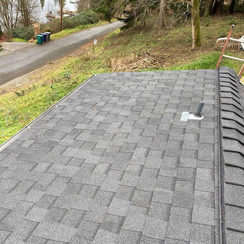 Asphalt shingle roof with pipe flashing and gutter guard