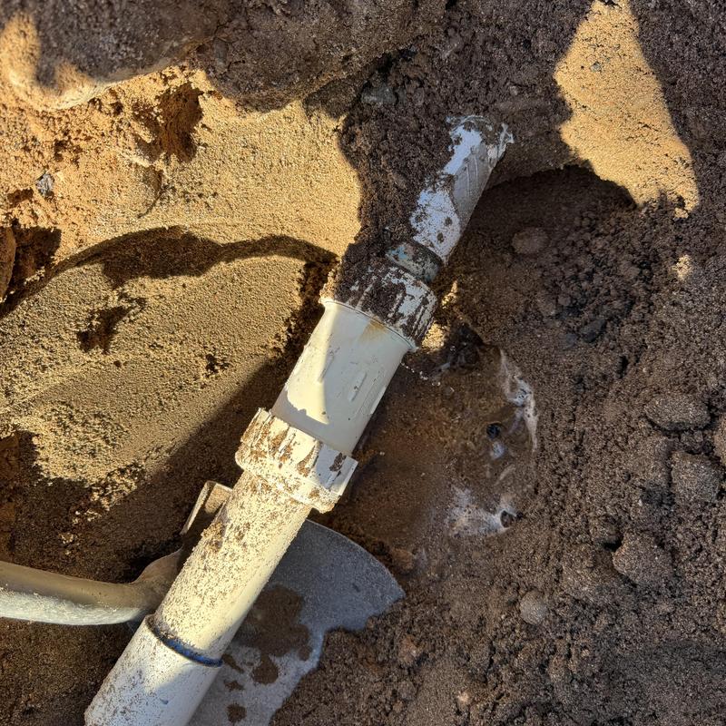 PVC water main with new coupling in soil excavation