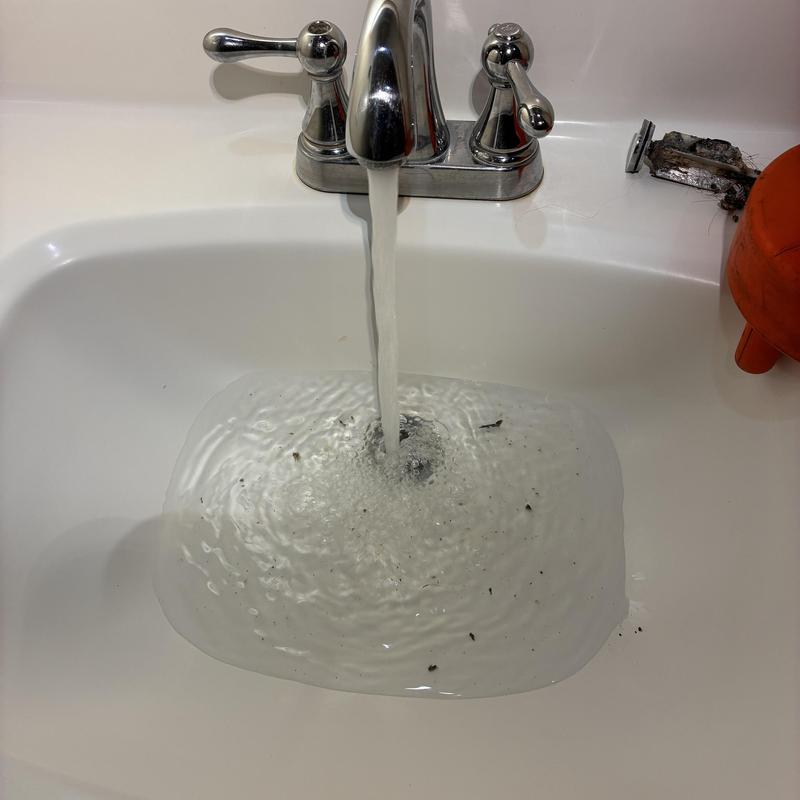 Basin sink drain clearing with flowing water