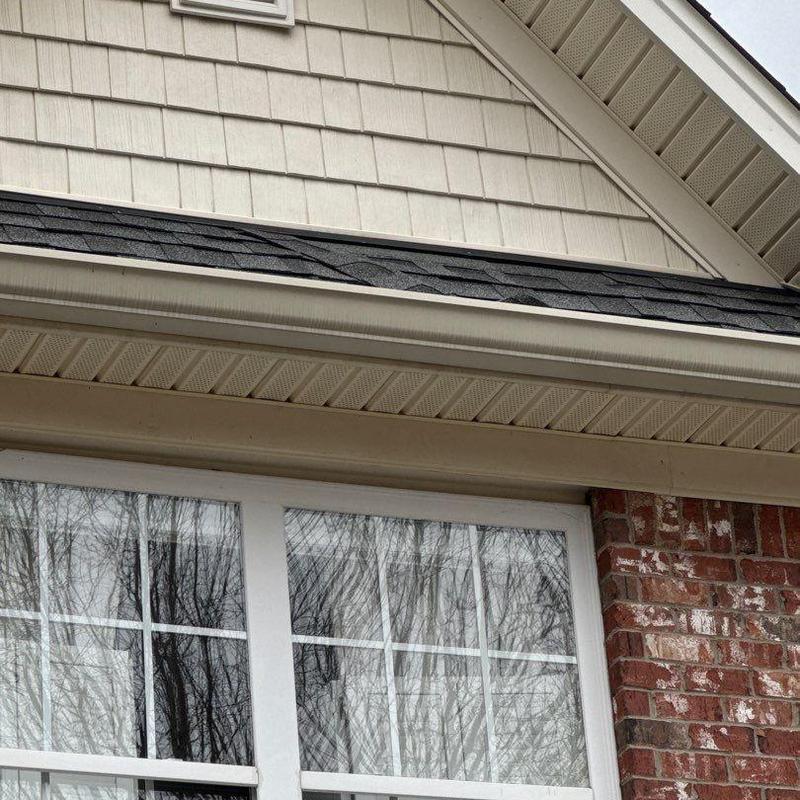 Roof shingles with hail damage on house exterior