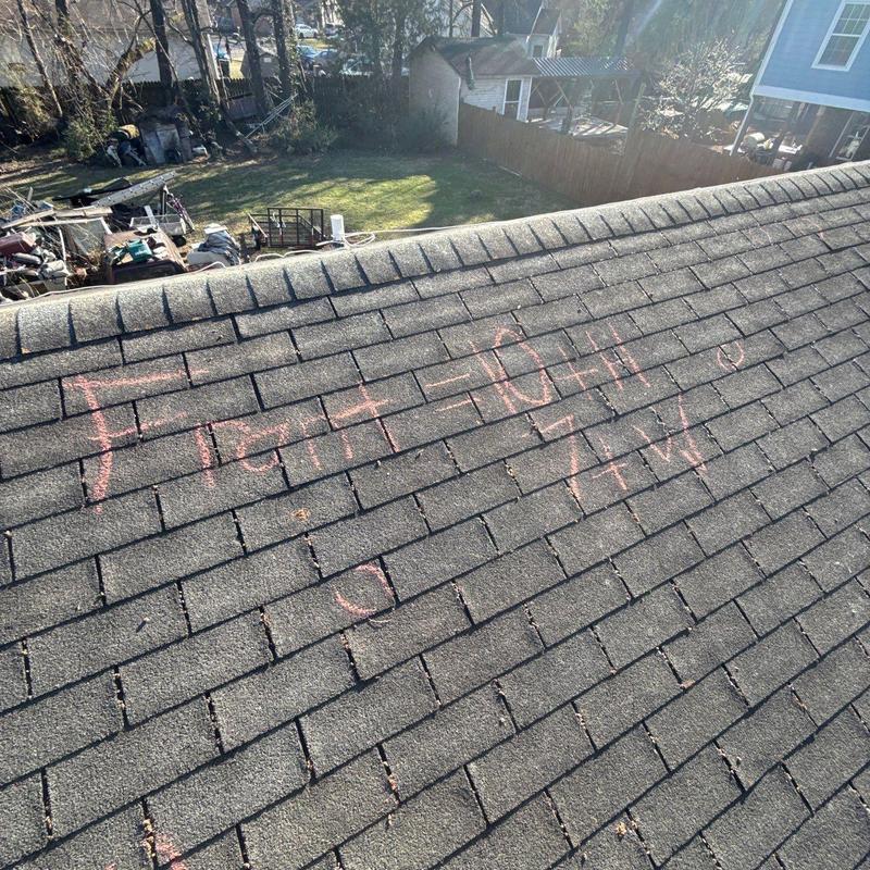 Asphalt shingle roof with hail damage markings