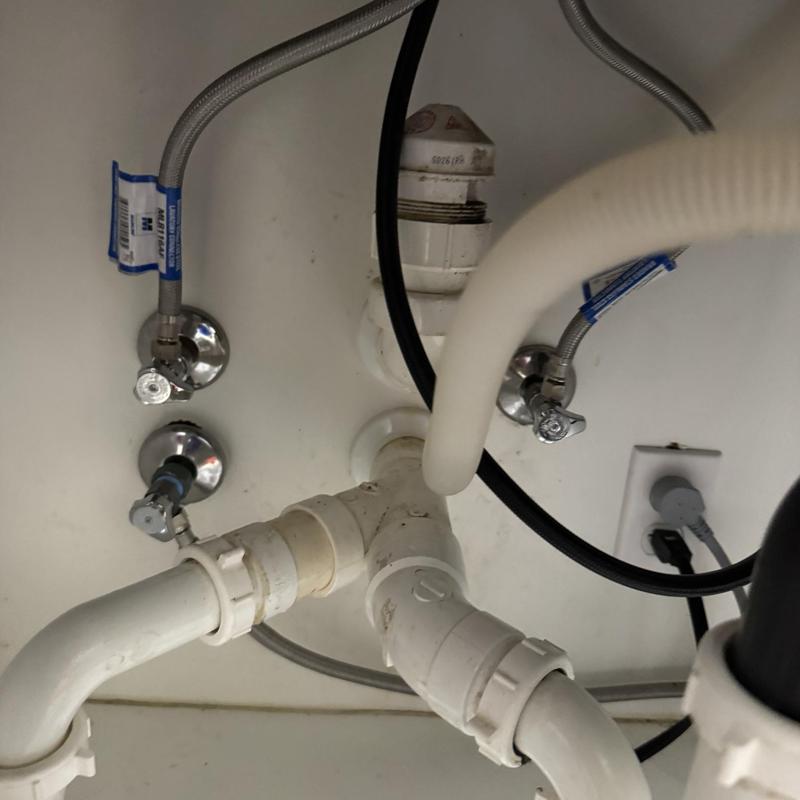 Kitchen faucet angle stop valves and drain pipes under sink