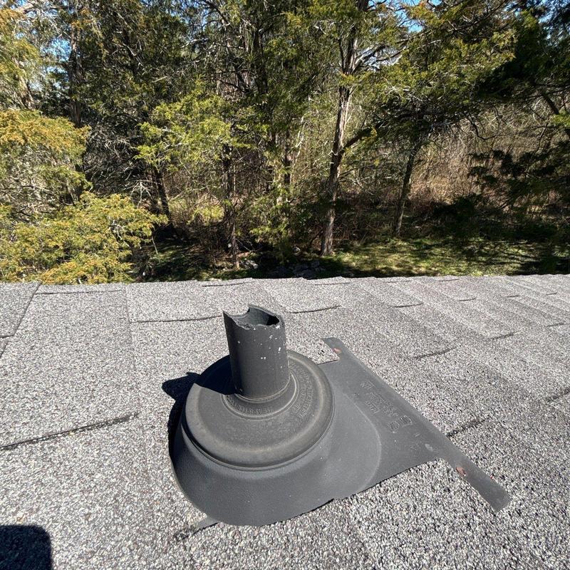 Roof vent flashing with torn rubber boot on shingle roof