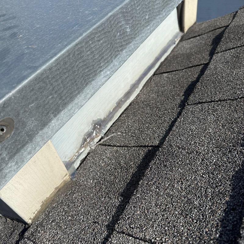 Flashing sealant on roof edge near metal flashing