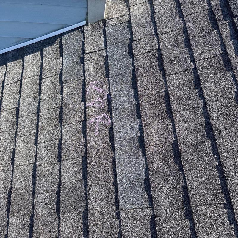 Asphalt shingle roof with hail damage markings