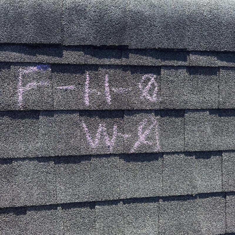 Asphalt shingles with chalk markings for hail damage inspection