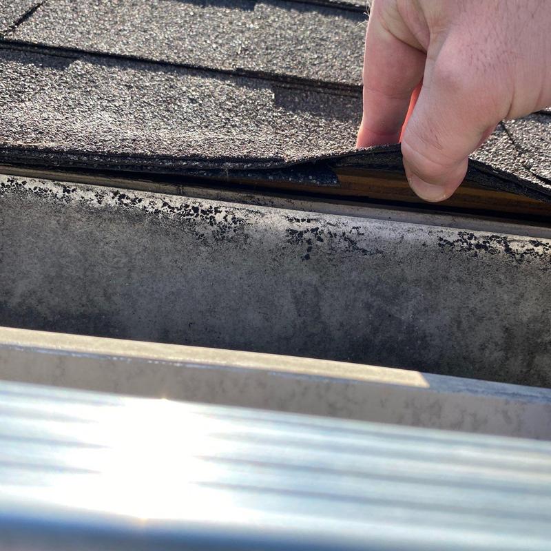 Roof shingles lifted to inspect damaged roof decking