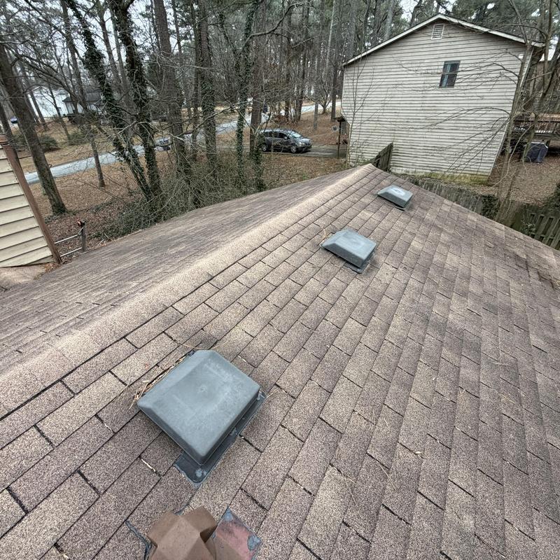 Box vents on golden cedar shingle roof with tarps installed