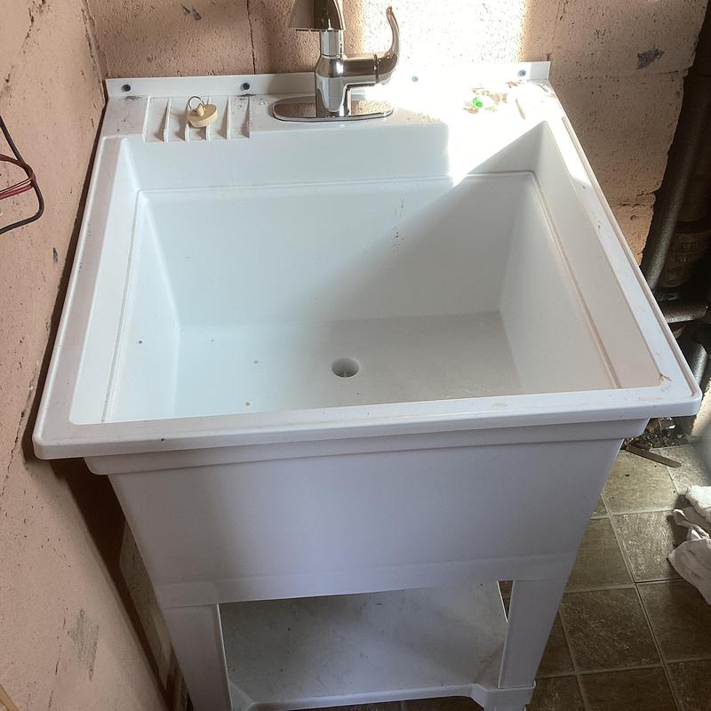 Utility sink with faucet installed in basement closet