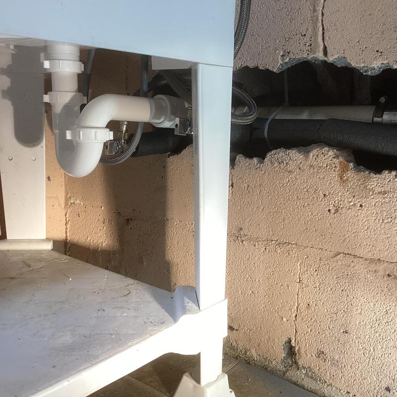 Utility sink PVC drain pipe installation in basement