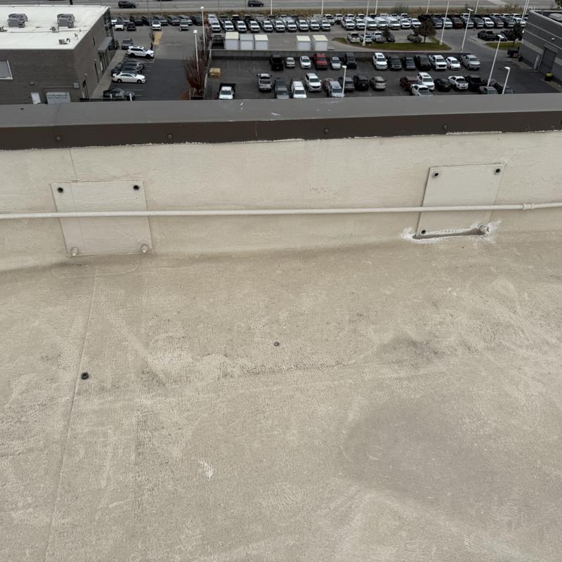 TPO roof with mounted conduit on parapet wall