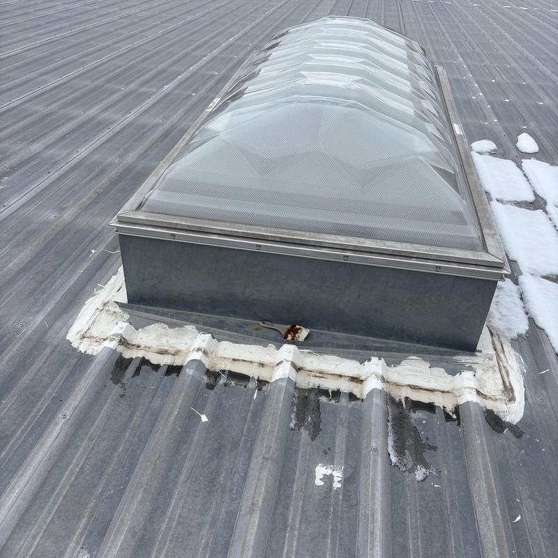 Commercial metal roof skylight with sealant on metal panels