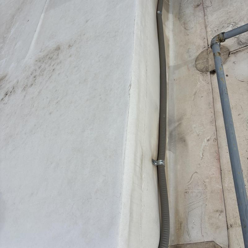 TPO commercial roof surface with conduit and pipe attachment