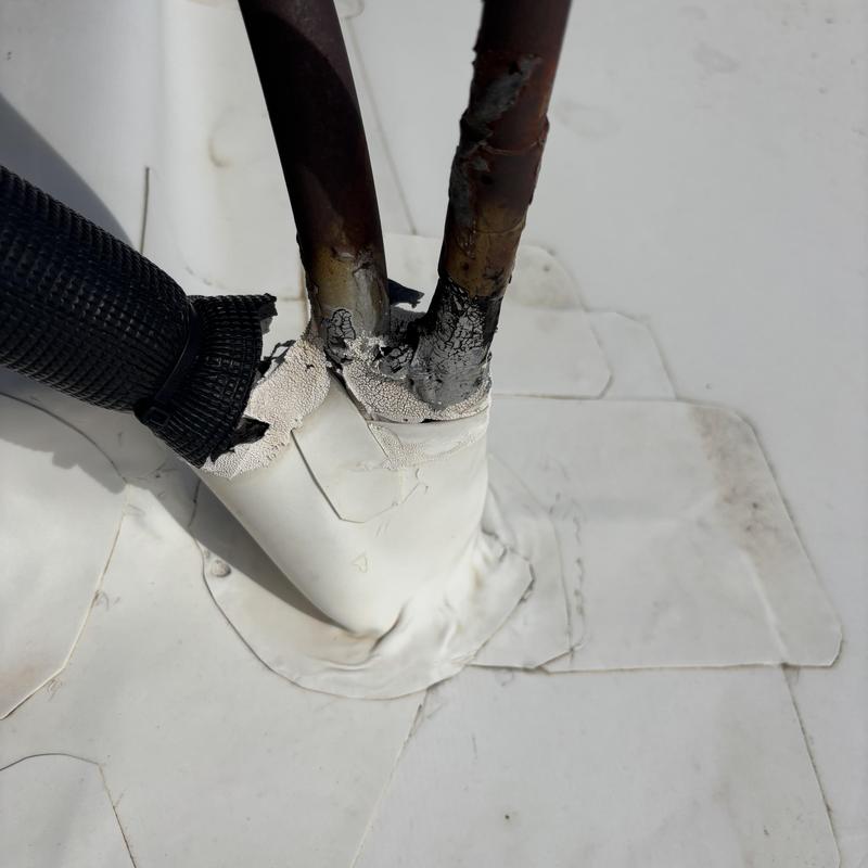 TPO roof penetration with damaged pipe insulation