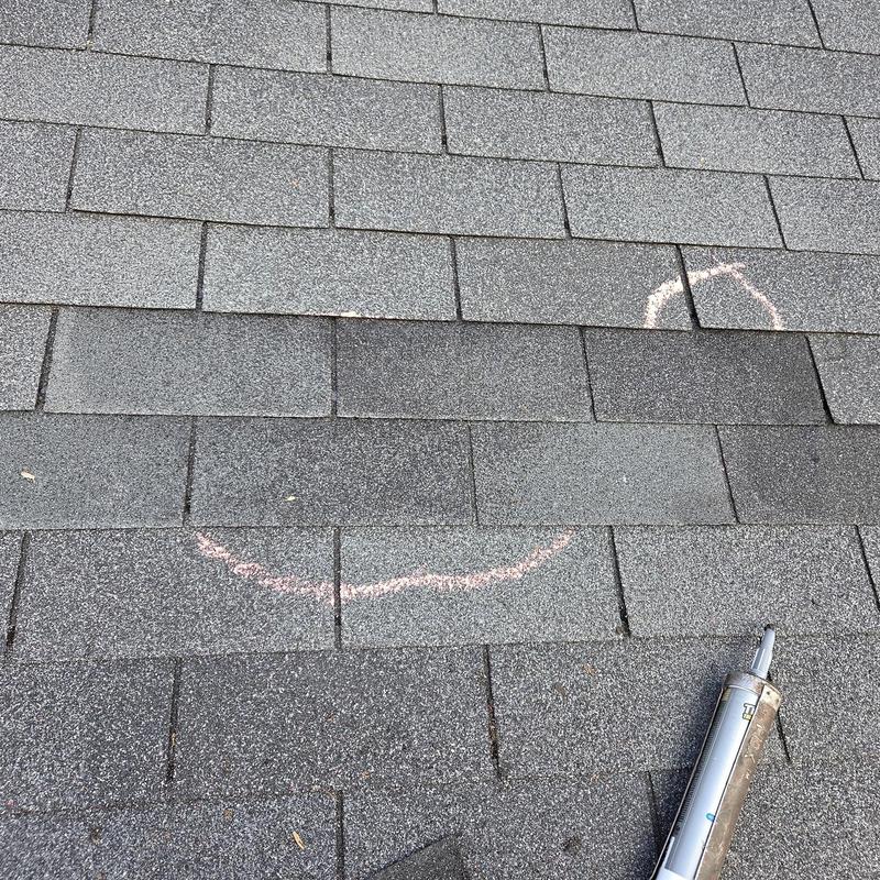 Asphalt shingles with marked damage and caulking tube