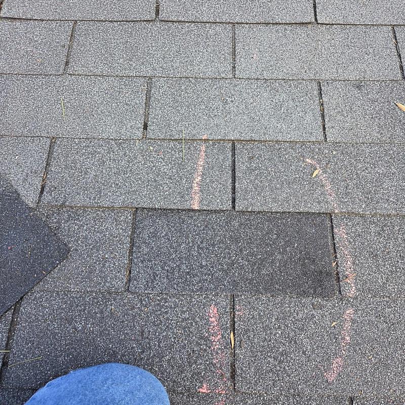 Asphalt roof shingles with chalk markings for replacement