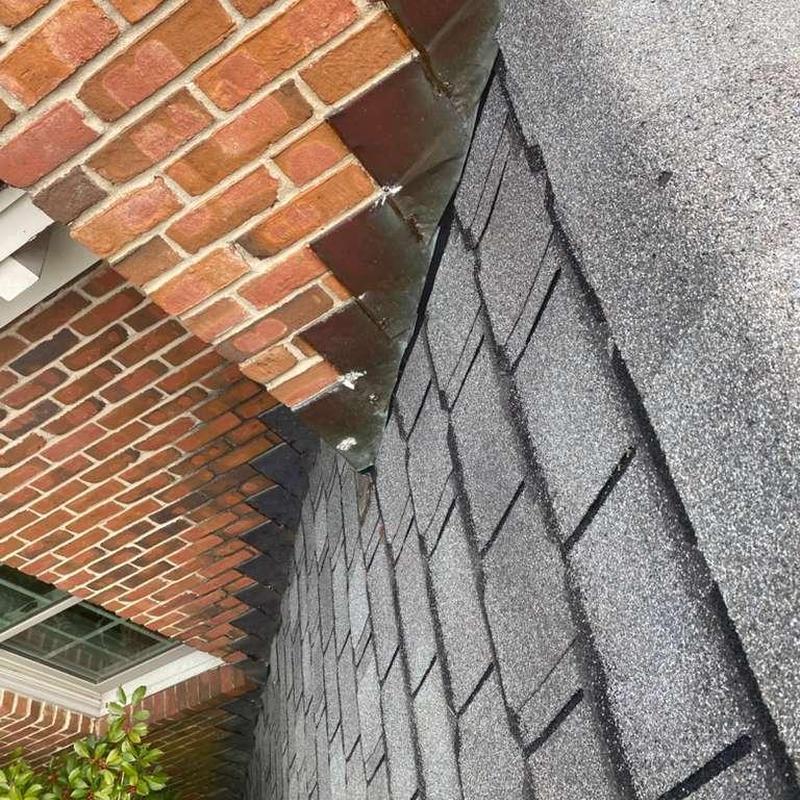 Roof shingles and brick chimney flashing inspection