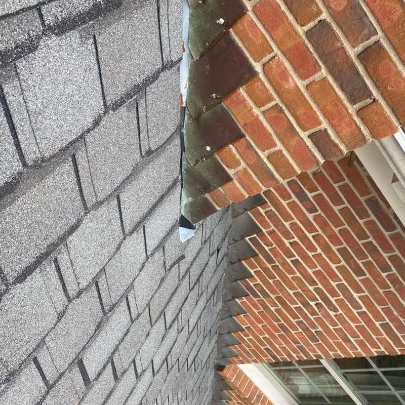 Asphalt shingle roof and brick chimney flashing inspection