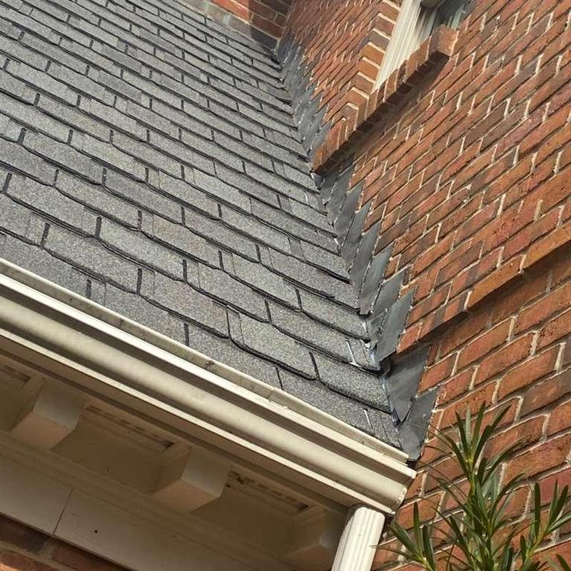 Asphalt shingle roof with metal flashing inspection