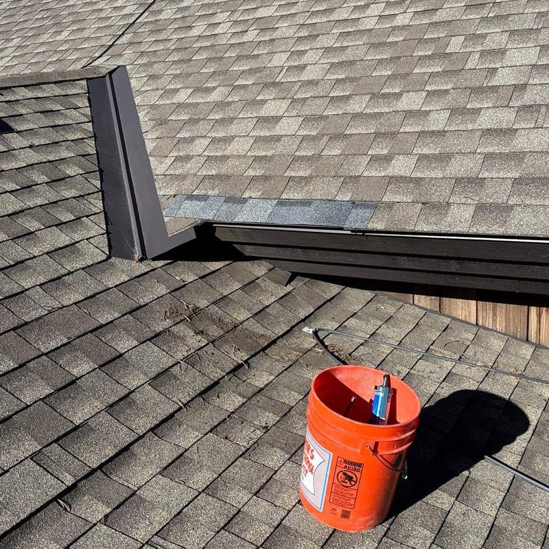 Shingle roof with heat tape installed near flashing