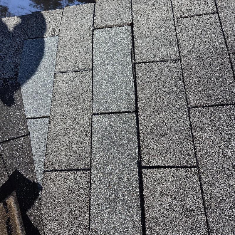 Asphalt roof shingles with new replacement patches