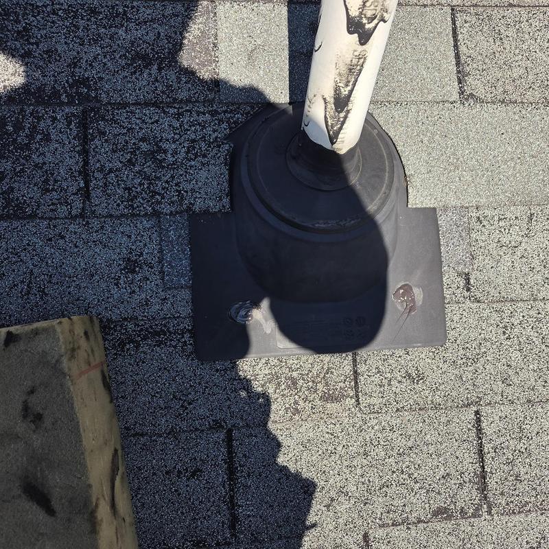 Roof vent flashing on shingle roof with caulk repairs