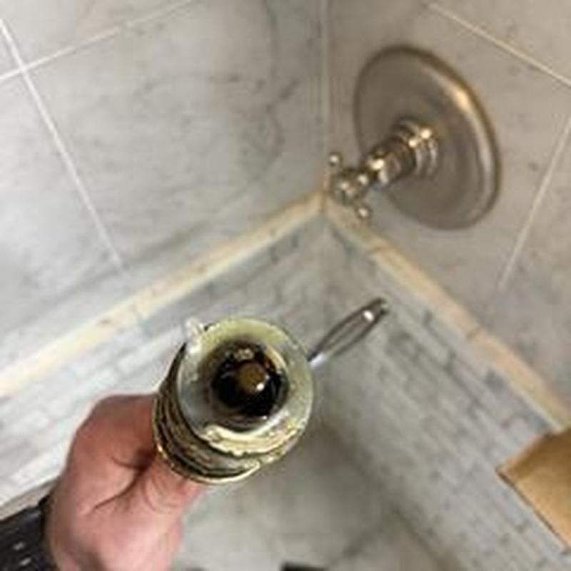 Shower cartridge removed showing scale buildup inside