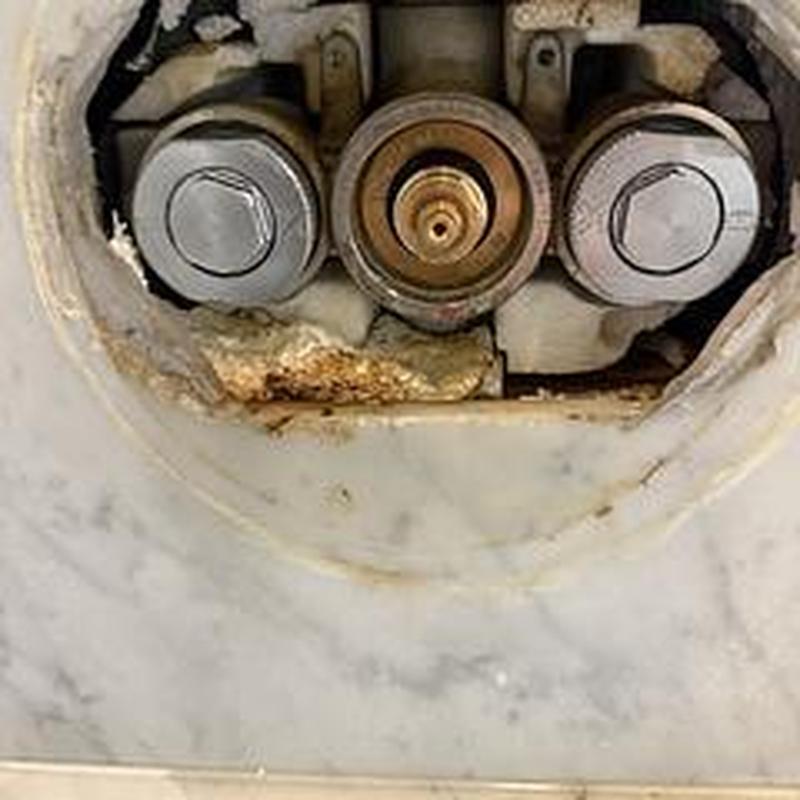 Shower cartridge valve with calcium buildup inside wall cavity