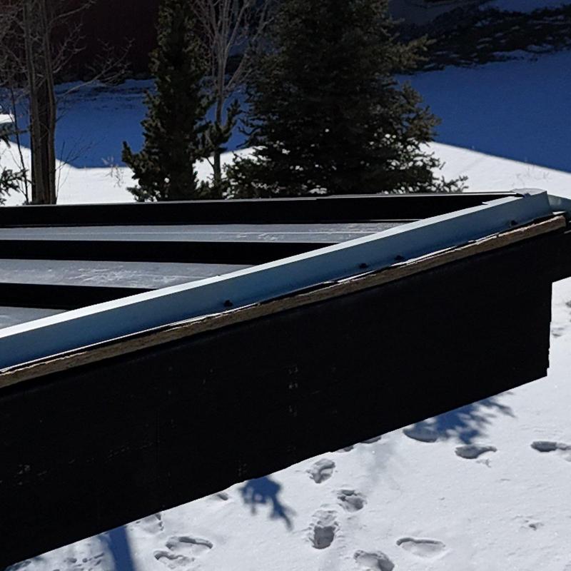 Standing seam metal roof edge with lifted panel