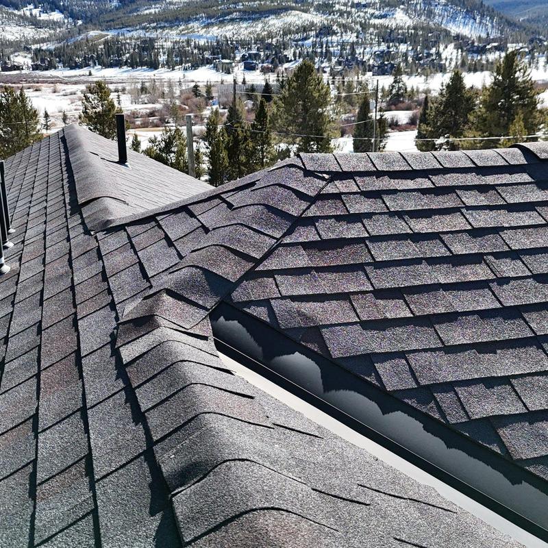 Asphalt shingle roof with visible lifting and buckling