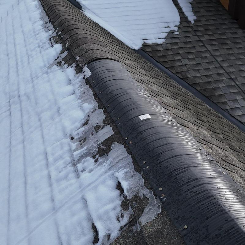GAF asphalt shingle roof ridge vent with snow