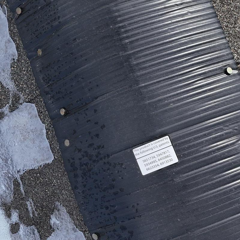 Rubber roof membrane with fasteners on shingle roof