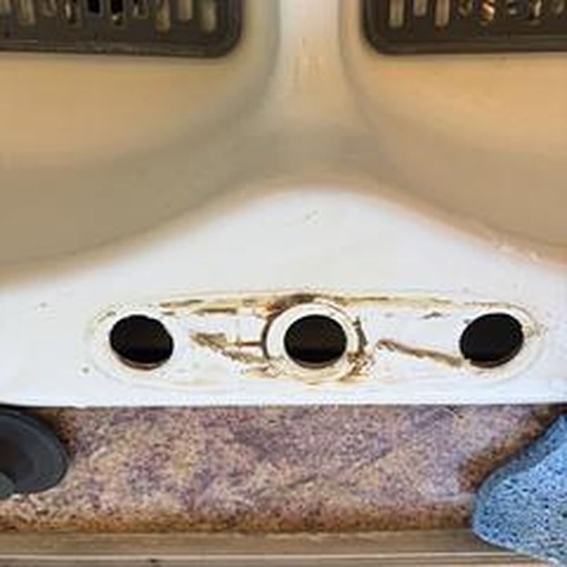 Kitchen sink faucet mounting holes with worn area