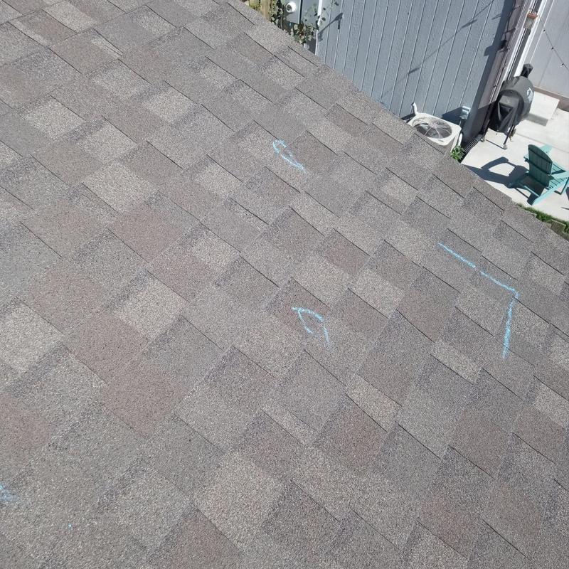 Shingle roof with chalk-marked hail damage inspection Shingle roof with chalk-marked hail damage inspection