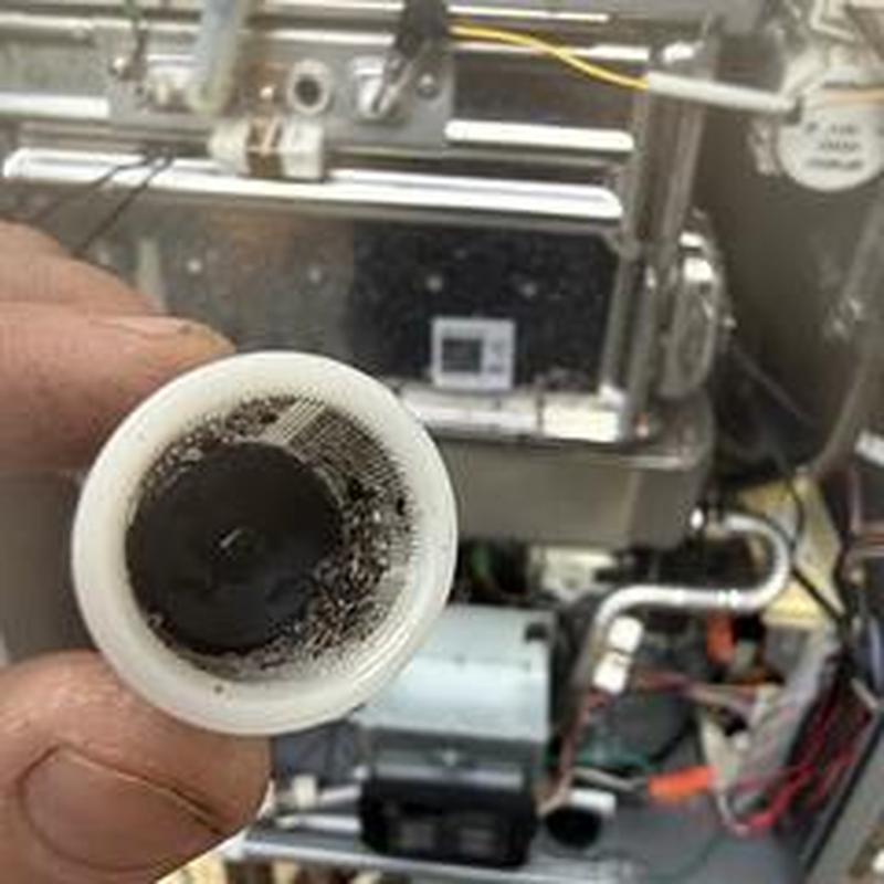 Water heater condensate cap clogged and removed