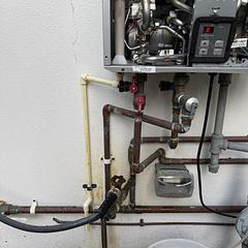 Tankless water heater ignition system with piping