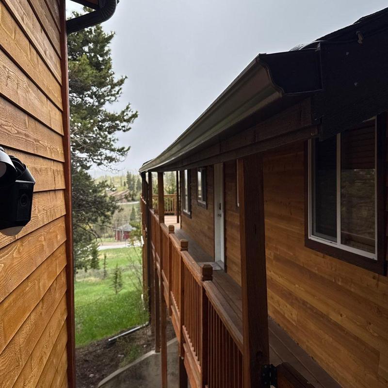 Gutter installation on wood-sided home exterior