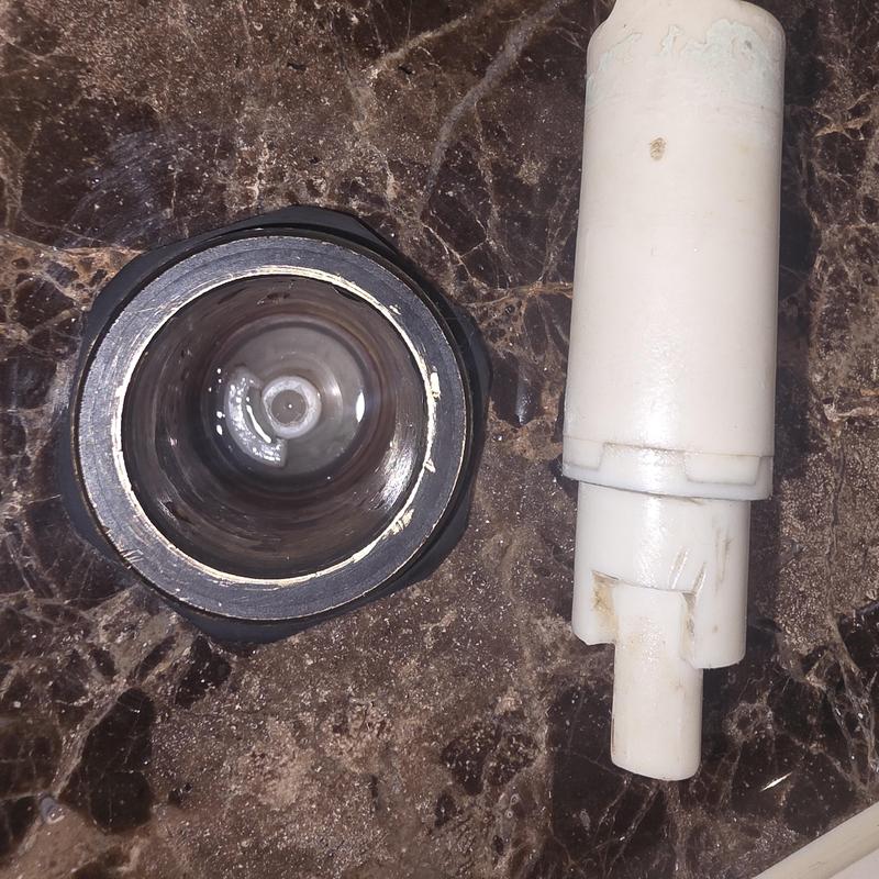 Roman tub diverter cartridge removed on marble surface