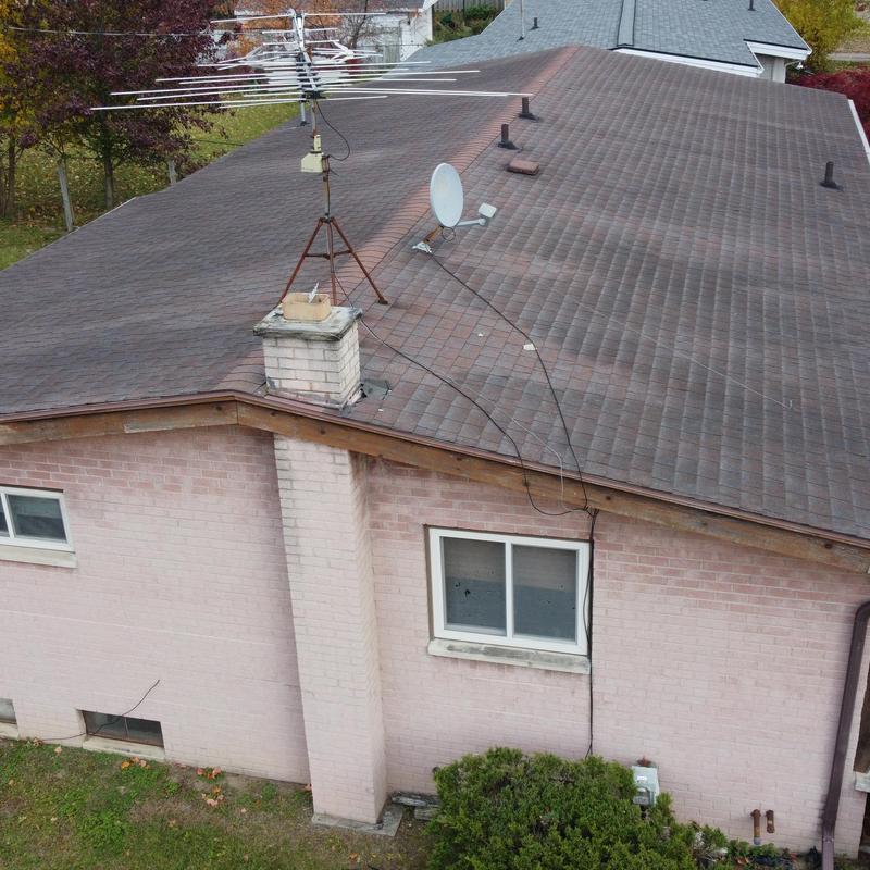 Asphalt shingle roof with antennas and chimney