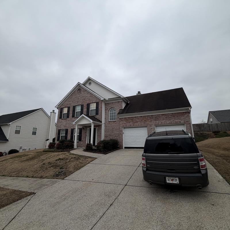 Roof with missing shingles and plumbing leak near spigot